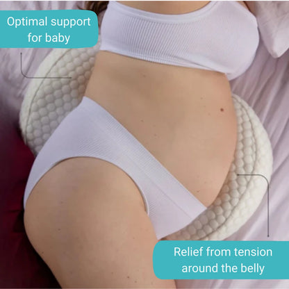 Pregnant woman using a maternity cushion for pregnancy support and postpartum relief