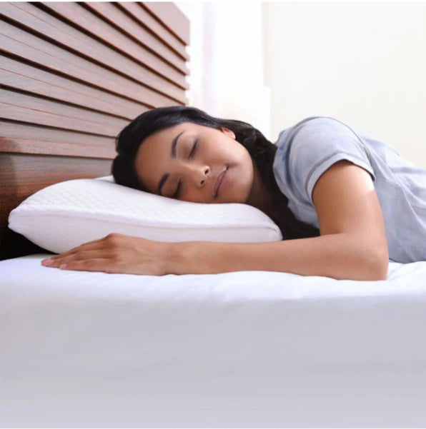 Woman enjoying a restful sleep with a cooling orthopedic pillow for neck pain relief and spinal support